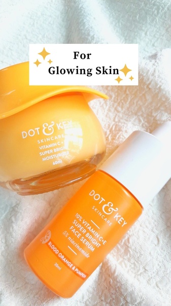 A high-key product photograph featuring a face serum and moisturizer with a clear, benefit-driven overlay text.